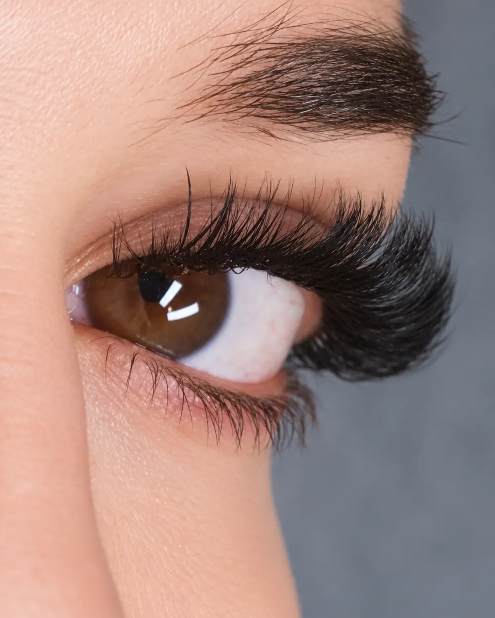 Side on close up of one client's eye with long lash extensions.